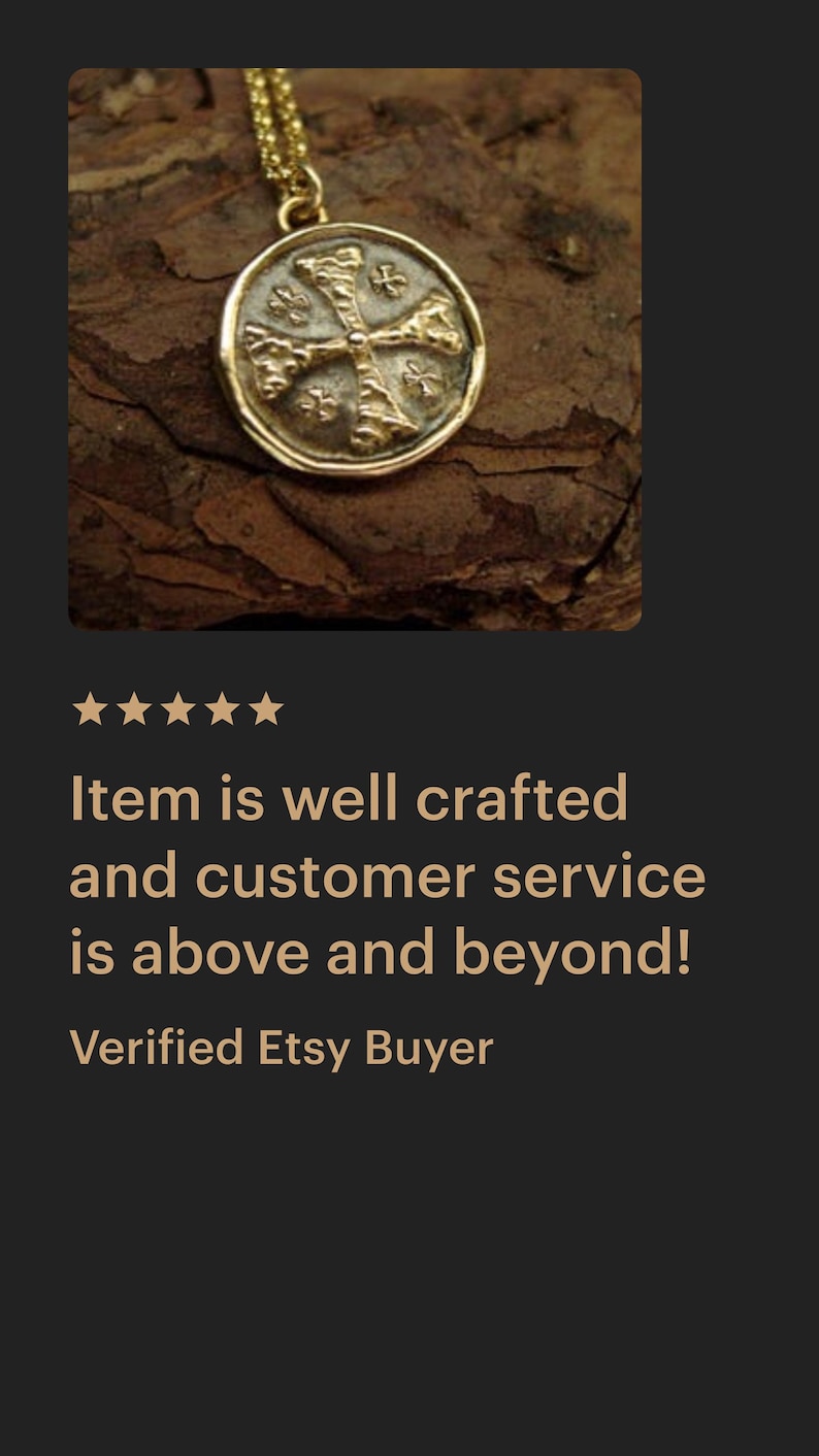 May include: A gold-toned circular pendant necklace featuring an embossed cross design with textured details. The pendant is suspended from a delicate gold-toned chain, showcasing a metallic finish and a distinct, raised cross motif on its face.