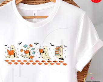 May include: White t-shirt featuring a Halloween-themed design. The graphic shows cartoon ghosts reading books, with bats and autumn leaves. The ghosts are in various poses, some reading, others holding stacks of books.