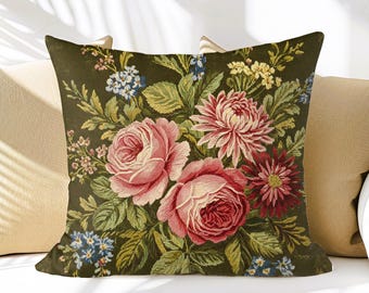 May include: A green throw pillow with a floral pattern featuring pink roses, white and red chrysanthemums, and blue forget-me-nots.
