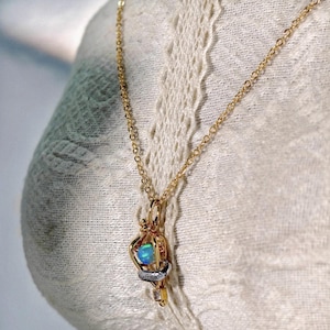 Felix Felicis lucky potion necklace displayed on a lace mannequin, illustrating its romantic and vintage aesthetic.