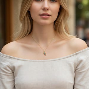 A woman wearing the dainty Felix Felicis lucky potion necklace, showing how the minimalist gold chain looks against the skin for a subtle, magical style.