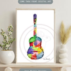 May include: A vertical rectangular print featuring a watercolor-style acoustic guitar silhouette filled with multicolored paint splatters and the lyrics to Come Thou Fount. The text includes the words Come Thou Fount of every blessing.