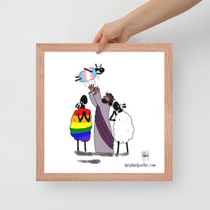 May include: A framed art print featuring a cartoon illustration. The artwork depicts a figure in a purple robe with arms raised, surrounded by stylized sheep, one with a rainbow design and another with a transgender flag. The frame is a light brown color.