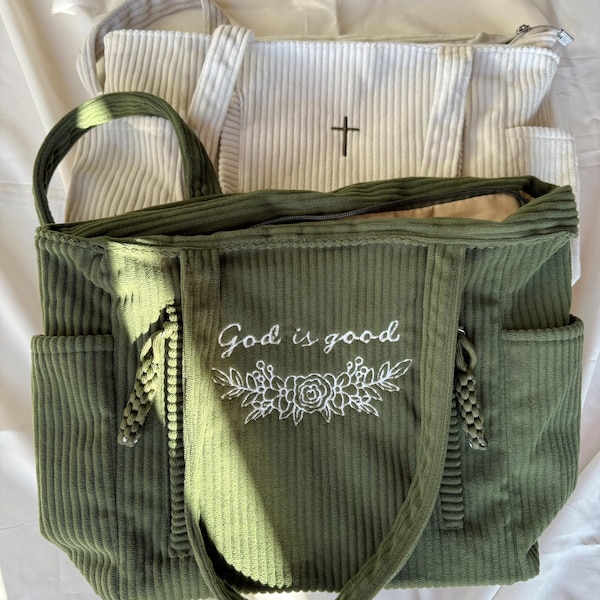 Bolso de hombro de pana bordado con múltiples cremalleras y bolsillos interiores. Diseño floral y de cruz "Dios es bueno".