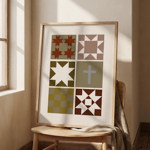 May include: A framed print featuring a patchwork quilt design with geometric patterns in shades of brown, green, and beige. The artwork is displayed on a wooden chair with a draped blanket.