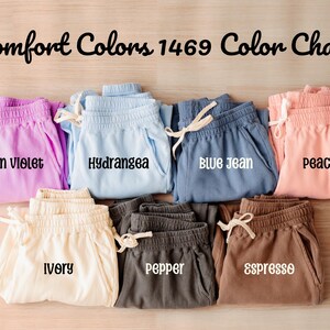 May include: Color chart of 10 different colors of sweatpants. The colors are: Neon Violet, Hydrangea, Blue Jean, Peachy, Ivory, Pepper, Espresso.