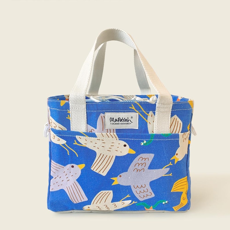 Kids’ cotton tote bag featuring playful bird illustrations on bright blue background by Mapayah.