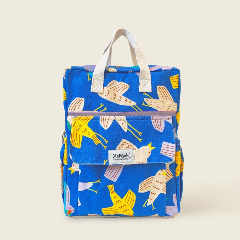 Bright blue kids backpack with colorful bird print, front pocket, and sturdy white handles — a fun and stylish school or travel bag for children.