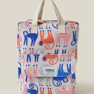 May include: A rectangular backpack with two top handles, featuring a light grey base with a repeating pattern of stylised monkeys in blue, orange, and pink. A front pocket flap displays a white label with the text Mapayah Childhood Adventures.