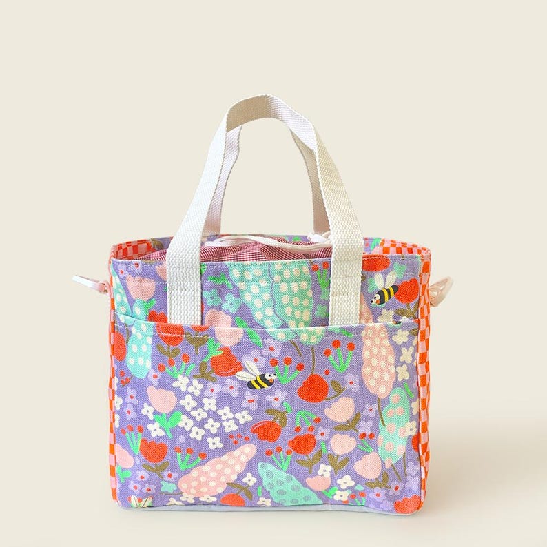 Kids’ floral-printed canvas tote bag with bees and berries design in purple and orange by Mapayah.