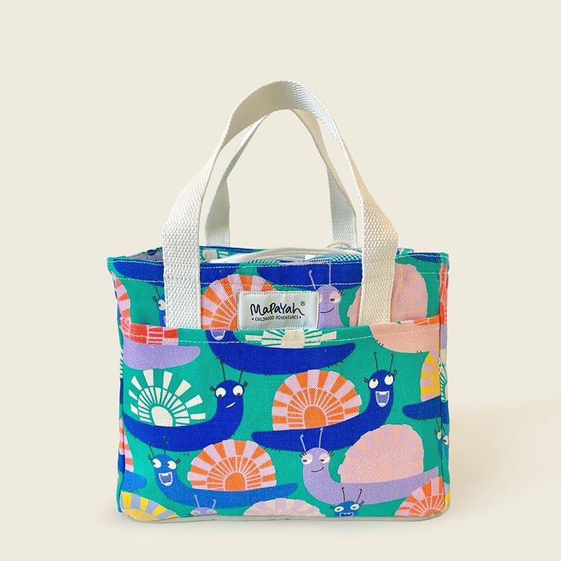 Colorful kids’ tote bag with cheerful snail print in green and blue canvas by Mapayah.