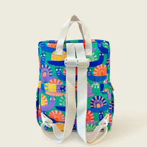 Back view of colorful snail-print kids backpack showing adjustable white straps and sturdy design - comfortable and playful for little explorers.