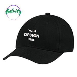May include: A black baseball cap with the text "YOUR DESIGN HERE" in white.