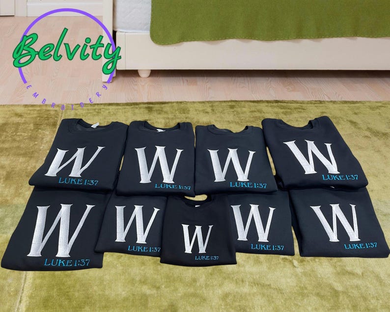May include: Eight black t-shirts with a white letter W and the text "LUKE 1:37" in blue.