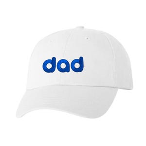 May include: White baseball cap with a blue "dad" embroidered on the front.
