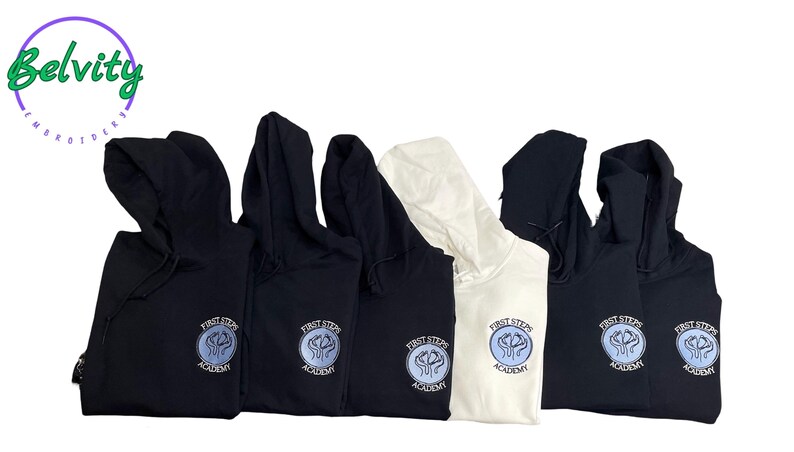 May include: Six black and white hooded sweatshirts with the logo "First Steps Academy" embroidered on the front. The logo is a circle with a blue and white design inside.