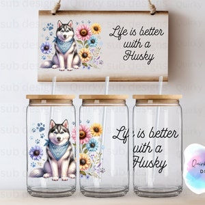 May include: Three clear glass tumblers with wooden lids and straws. Each tumbler has a different design. One has a husky dog with flowers, another has a husky dog with paw prints, and the third has the text "Life is better with a Husky".