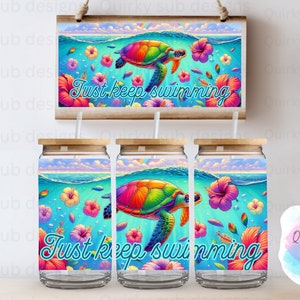 May include: Three clear glass tumblers with a rainbow coloured sea turtle and tropical flowers design. The tumblers have a wooden lid and the text "Just keep swimming" is printed on the front.
