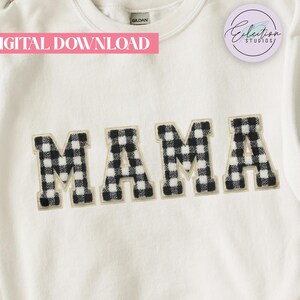 May include: White sweatshirt featuring the word "MAMA" in black and white buffalo check letters. The garment has a crew neck and long sleeves. The words "DIGITAL DOWNLOAD" are printed in pink.