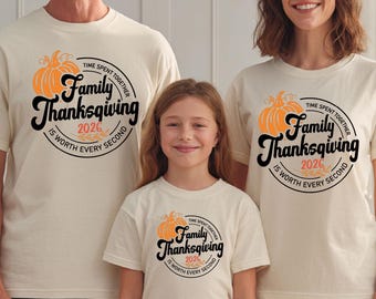 May include: Three off-white short-sleeve t-shirts featuring a graphic of an orange pumpkin and black text that reads Family Thanksgiving 2026 Time Spent Together Is Worth Every Second. The shirts have a crew neckline and a standard fit.