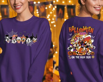 May include: A purple long-sleeve sweatshirt featuring a front graphic of cartoon characters in spiderwebs and a back graphic with the text HALLOWEEN 2026 ON THE HIGH SEAS, depicting characters with pumpkins, a ship wheel, and an anchor in a festive design.