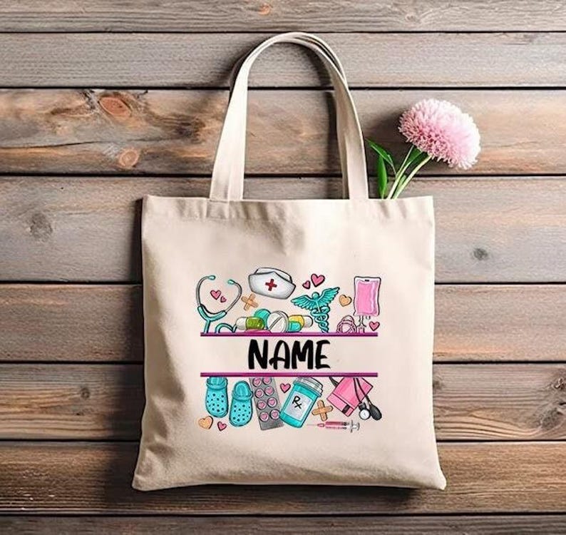 May include: A white canvas tote bag with a pink and blue design featuring medical symbols, pills, and the word "NAME".