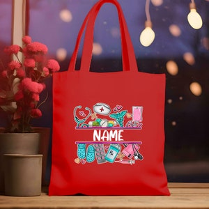 May include: Red tote bag with a personalized name and a design featuring medical symbols, pills, and a stethoscope. The design is in a cartoon style with bright colors.