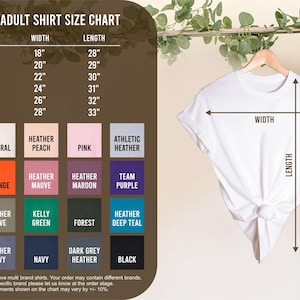 K&ouml;nnte beinhalten: Ein wei&szlig;es T-Shirt auf einem Kleiderb&uuml;gel, mit einer Gr&ouml;&szlig;entabelle links. Die Tabelle zeigt Ma&szlig;e in Zoll f&uuml;r Unisex-Erwachsenenhemden und eine Farbpalette.