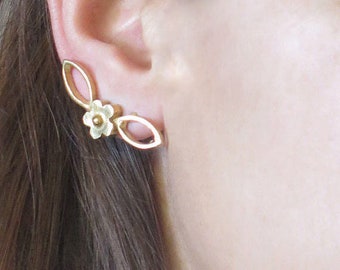 May include: Gold-toned ear cuff featuring a floral design with a small flower and two leaf-shaped accents. The jewelry is worn on the ear, showcasing its delicate details and elegant style. This ear cuff is a fashionable accessory.