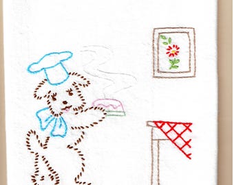 Vintage stylee tea towel hand embroidered with a dog holding a cake