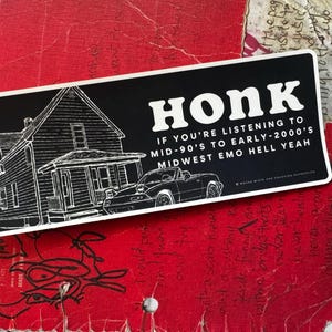 May include: Black and white sticker with the word "Honk" in large white letters. The sticker features a house and a car illustration. Text reads: "If you're listening to mid-90's to early-2000's Midwest Emo Hell Yeah."