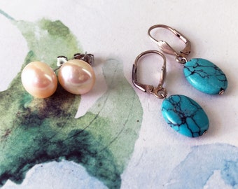 May include: A pair of pearl stud earrings and a pair of turquoise dangle earrings. The pearl earrings are white and the turquoise earrings are blue with black veins.
