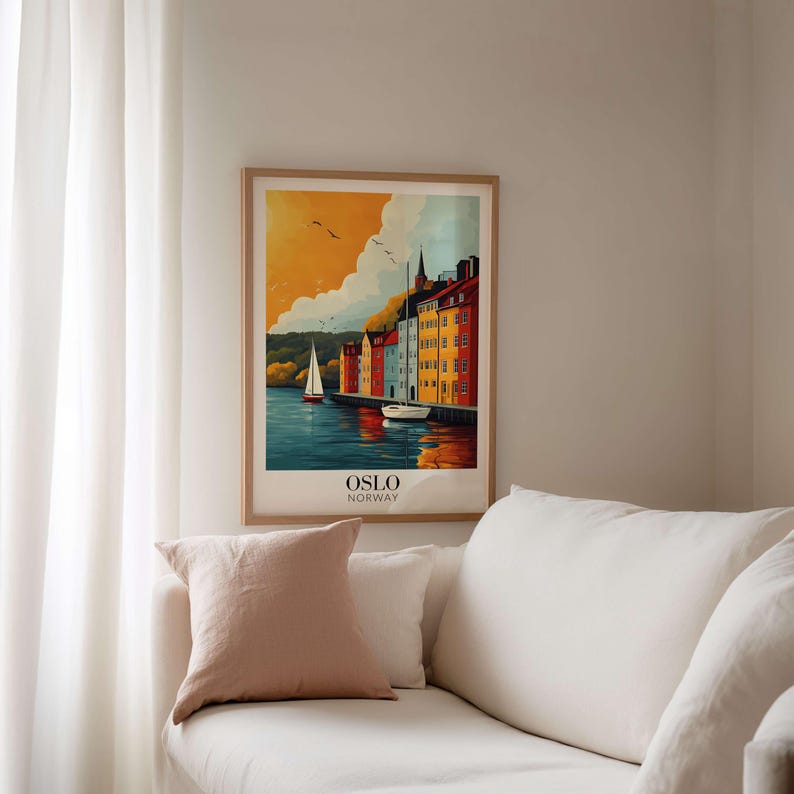 a cozy living room with a white couch and a framed poster of a colorful cityscape hanging on the wall.