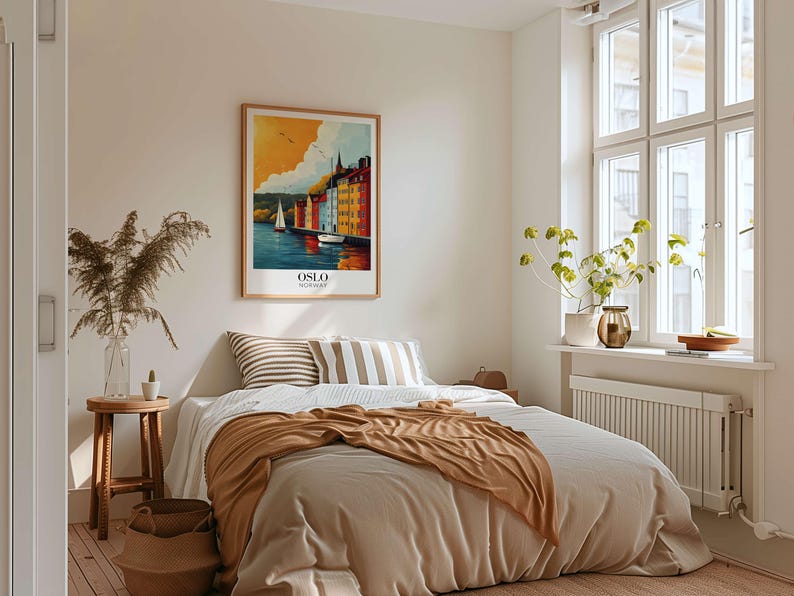 a cozy bedroom with a large bed, a framed poster of a scenic view, and various decorative elements such as a potted plant and a vase.