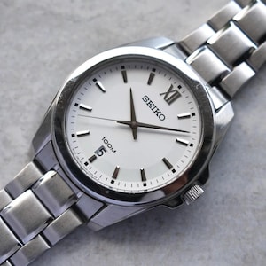 Seiko 100M Men&#39;s Watch White Dial Date Quartz Steel Bracelet