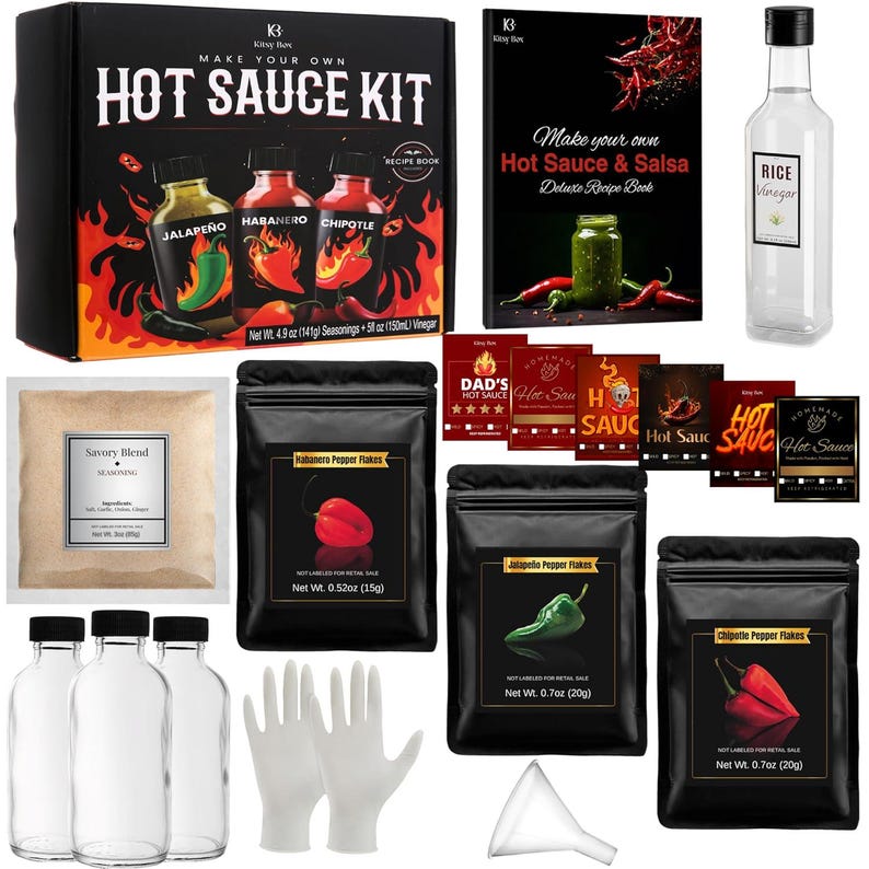 May include: A hot sauce kit with a recipe book, seasonings, and vinegar. The kit includes bottles, pepper flakes, and gloves. The box features the text "Make Your Own Hot Sauce Kit" with images of jalape&ntilde;o, habanero, and chipotle peppers.