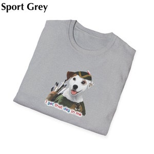 May include: Sport grey t-shirt featuring a graphic of a dog dressed as an archer with the text "I got that dog in me". The dog is wearing a green and brown hat and outfit, with a quiver of arrows.