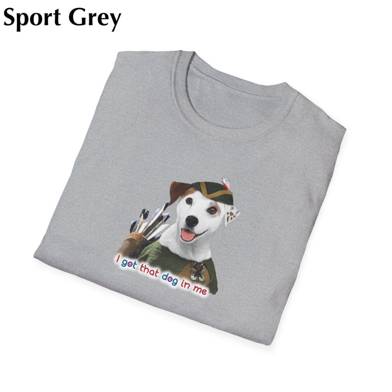 May include: Sport grey t-shirt featuring a graphic of a dog dressed as an archer with the text "I got that dog in me". The dog is wearing a green and brown hat and outfit, with a quiver of arrows.