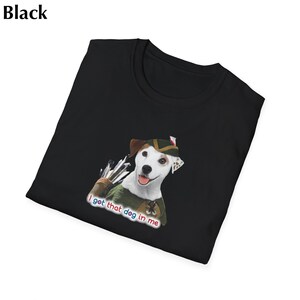 May include: Black t-shirt featuring a cartoon dog dressed as Robin Hood with a quiver of arrows. The text "I got that dog in me" is printed below the dog. The shirt is folded.
