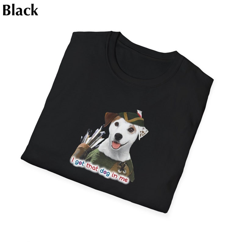 May include: Black t-shirt featuring a cartoon dog dressed as Robin Hood with a quiver of arrows. The text "I got that dog in me" is printed below the dog. The shirt is folded.