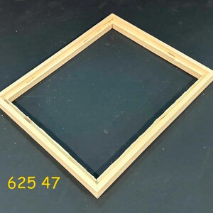 May include: A rectangular wooden picture frame with a light natural finish and a beveled inner edge. The frame is empty and features mitered corners. The yellow text 625 47 is visible in the lower left corner of the image, indicating a specific model.