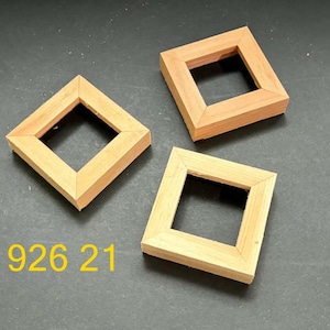 May include: Three square wooden frames with mitered corners and a natural light brown finish. The frames are arranged in a cluster, and the yellow text 926 21 is visible in the lower left corner of the image, indicating a specific product identifier.