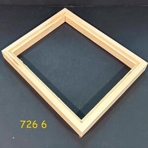 May include: A rectangular light-colored wooden picture frame with a beveled inner edge and a natural grain finish. The frame is empty and features the yellow text 726 6 printed in the lower left corner, indicating a specific model or size identifier.