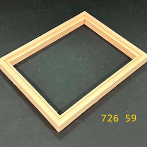 May include: A rectangular light-colored wooden frame with a stepped profile and a smooth finish. The frame is positioned at an angle and features the yellow text 726 59 printed in the lower right corner, indicating a specific model or item number.