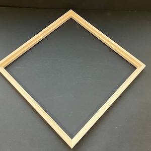 May include: A light wood picture frame with a diamond shape.