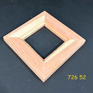 May include: A square wooden frame oriented in a diamond shape, featuring a natural light brown wood grain finish with mitered corners and a recessed inner edge. The yellow text 726 52 is printed in the lower right corner of the frame.