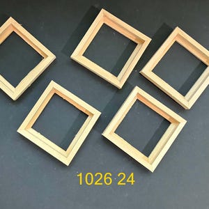 May include: Five square wooden frames arranged in a cluster, each featuring a light natural wood finish with mitered corners and a hollow center. The text 1026 24 is printed in yellow at the bottom center of the image.