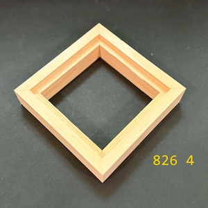 May include: A square wooden frame with a light tan natural wood grain finish, featuring a stepped inner edge profile. The frame is oriented as a diamond shape. The yellow text 826 4 is visible in the lower right corner of the image.