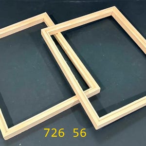 May include: Two rectangular light-colored wooden frames with a smooth finish and a stepped inner edge profile. The frames are positioned overlapping each other. The yellow text 726 56 is visible at the bottom center of the image.