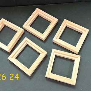 May include: Five square, light-colored wooden frames arranged in a cluster. Each frame features a simple, flat profile with mitered corners. The text 726 24 is printed in yellow in the bottom left corner of the image, indicating the product model.